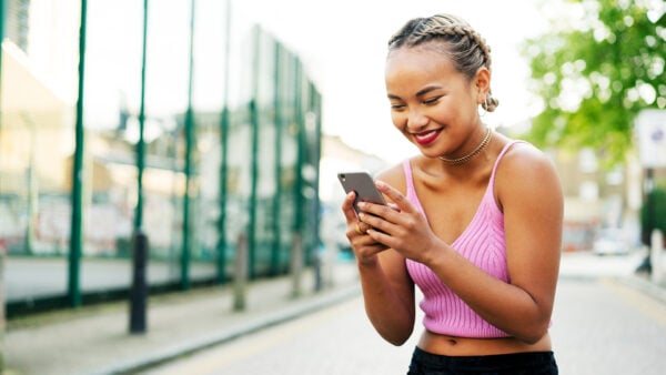 An adult woman is using a dating site or app on her phone